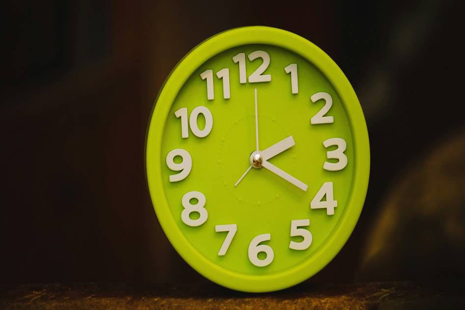 Modern smart clock on wooden shelf with minimalist home decor
